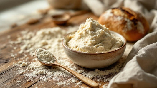 Sourdough starter with a domed top at peak rise next to measuring spoons on a farmhouse table — sourdough starter vs discard guide from Mother's Country Store